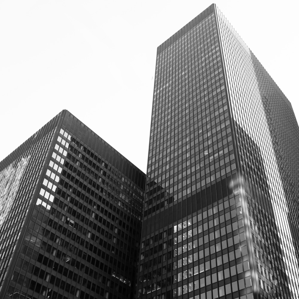 B&W photo looking up at two office buildings